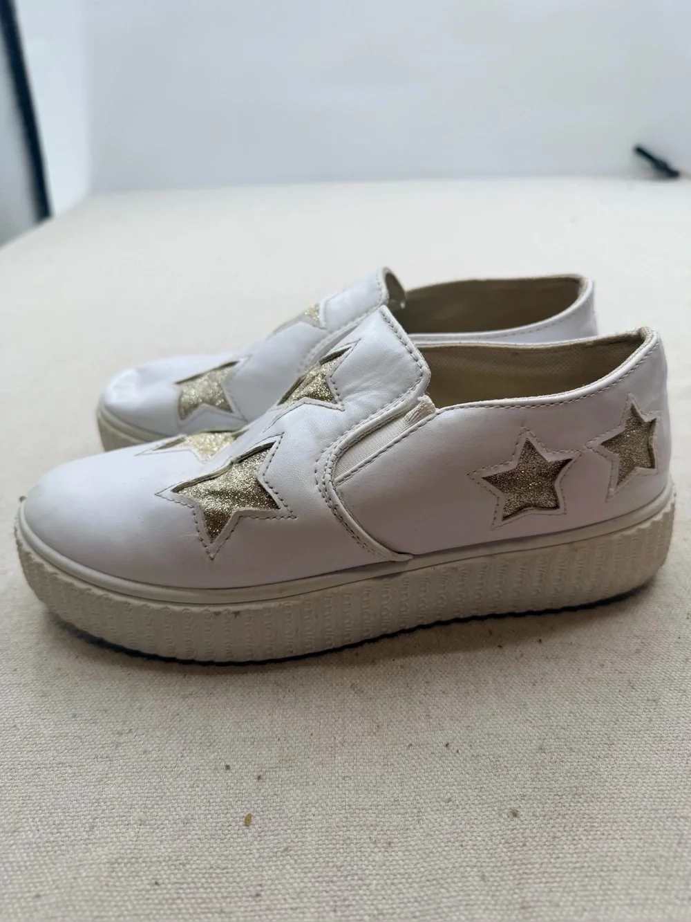 ' White Slip-On Sneakers with Gold Star Accents